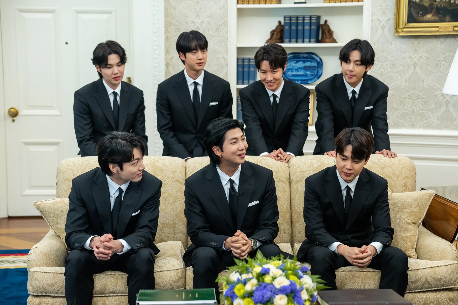 The seven members of BTS standing together at the White House on May 31, 2022