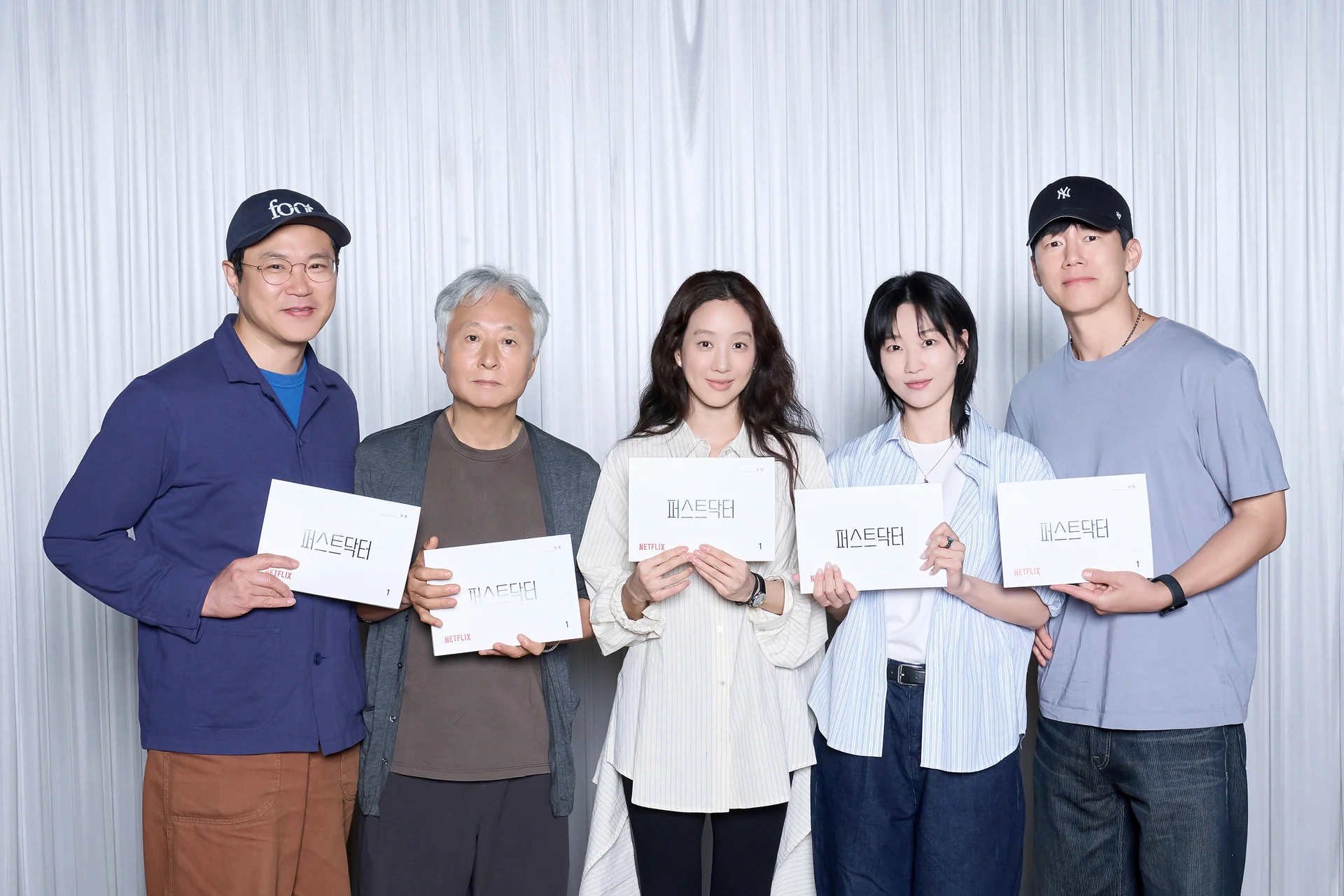 The five lead actors of Netflix series First Doctor holding scripts for the production announcement